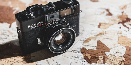 black Konica SLR camera on map